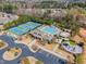 A birds eye view of community amenities, including tennis courts, pool, and playground, nestled among vibrant trees at 2305 Everstone Rd, Wake Forest, NC 27587