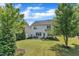 Spacious backyard with green lawn and a patio set, perfect for outdoor living at 2305 Everstone Rd, Wake Forest, NC 27587