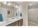Well-lit bathroom with double sinks, tile flooring, and shower/tub combo at 2305 Everstone Rd, Wake Forest, NC 27587