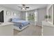 A comfortable bedroom features a ceiling fan, window and neutral decor at 2305 Everstone Rd, Wake Forest, NC 27587