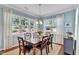 Bright dining room with a wood table, garden views, and stylish curtains creates an inviting space at 2305 Everstone Rd, Wake Forest, NC 27587