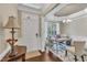 Bright home office featuring elegant trimwork, a modern desk, a chandelier, and natural light at 2305 Everstone Rd, Wake Forest, NC 27587
