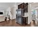 View of the kitchen featuring stainless steel refrigerator, dark wood cabinets, and hardwood floors at 2305 Everstone Rd, Wake Forest, NC 27587