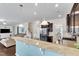 Open-concept kitchen with granite countertops, stainless steel appliances, and a breakfast bar overlooking the living room at 2305 Everstone Rd, Wake Forest, NC 27587