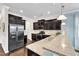 Gourmet kitchen with dark cabinets, stainless steel appliances, and granite countertops is a chef's dream at 2305 Everstone Rd, Wake Forest, NC 27587