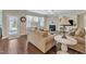 Cozy living room with hardwood floors, a fireplace, a ceiling fan, and ample natural light at 2305 Everstone Rd, Wake Forest, NC 27587