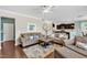Inviting living room features plush sofas, a ceiling fan, and an open floor plan into the kitchen at 2305 Everstone Rd, Wake Forest, NC 27587