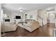 Bright living room featuring hardwood floors, a fireplace, and staircase access at 2305 Everstone Rd, Wake Forest, NC 27587