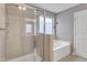 Spa-like main bathroom with a walk-in shower, soaking tub, and elegant fixtures at 2305 Everstone Rd, Wake Forest, NC 27587