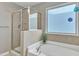 The main bathroom features a luxurious soaking tub and a glass-enclosed shower at 2305 Everstone Rd, Wake Forest, NC 27587