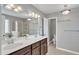 Main bathroom with double sinks, dark wood cabinets, and separate tub and shower at 2305 Everstone Rd, Wake Forest, NC 27587
