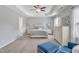 Light-filled main bedroom with a tray ceiling, large windows, and neutral decor at 2305 Everstone Rd, Wake Forest, NC 27587