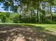 Expansive backyard features mature trees and lush greenery, offering a private and serene outdoor space at 235 Stephenson Rd, Benson, NC 27504