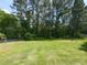 Expansive backyard featuring lush green grass, mature trees, and plenty of space at 235 Stephenson Rd, Benson, NC 27504