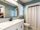 Bathroom features a modern vanity, framed mirror, and shower with white tile surround at 235 Stephenson Rd, Benson, NC 27504