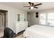 Bright bedroom features a ceiling fan, dresser, and abundant natural light at 235 Stephenson Rd, Benson, NC 27504