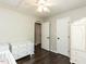 Bedroom featuring hardwood floors, neutral paint, and white furniture and trim throughout at 235 Stephenson Rd, Benson, NC 27504