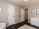 Cozy bedroom featuring hardwood floors, neutral paint, and white trim throughout at 235 Stephenson Rd, Benson, NC 27504