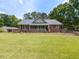 Charming one story brick home with a well manicured front lawn and a covered front porch at 235 Stephenson Rd, Benson, NC 27504