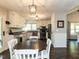 Bright eat-in kitchen with white cabinets, stainless appliances, and stylish pendant lighting at 235 Stephenson Rd, Benson, NC 27504