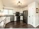 Updated kitchen features stainless appliances, dark countertops, and wood-look flooring at 235 Stephenson Rd, Benson, NC 27504