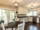 Eat-in kitchen featuring white cabinets, dark countertops and stainless appliances at 235 Stephenson Rd, Benson, NC 27504