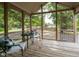 Relaxing screened-in porch with comfortable chairs and a view of the backyard at 235 Stephenson Rd, Benson, NC 27504