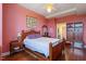 This bedroom offers a wooden bed frame, hardwood floors, and access to the ensuite bathroom at 2410 Environ Way, Chapel Hill, NC 27517