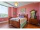 Charming bedroom features hardwood floors, a ceiling fan, and natural light from a large window at 2410 Environ Way, Chapel Hill, NC 27517