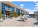 Condo building exterior with a pool, patio, and lounge chairs at 2410 Environ Way, Chapel Hill, NC 27517