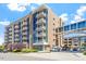Modern building exterior with private balconies, pedestrian bridge and attractive landscaping at 2410 Environ Way, Chapel Hill, NC 27517