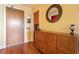 Entry foyer with wood floors, coat closet and storage cabinet at 2410 Environ Way, Chapel Hill, NC 27517