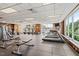Well-equipped community gym with treadmills, weight machines, and large windows at 2410 Environ Way, Chapel Hill, NC 27517