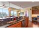 This kitchen features a granite counter that flows to a dining area with views at 2410 Environ Way, Chapel Hill, NC 27517