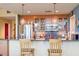 Kitchen featuring stainless steel appliances, tile backsplash, glass cabinets and bar seating at 2410 Environ Way, Chapel Hill, NC 27517