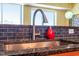 Kitchen sink with granite counters and backsplash, stainless faucet and stylish decor at 2410 Environ Way, Chapel Hill, NC 27517