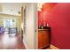 This powder room features granite counters, wood cabinets and vibrant red walls at 2410 Environ Way, Chapel Hill, NC 27517