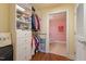 Walk-in closet with custom shelving, hanging rods, and access to the ensuite bathroom at 2410 Environ Way, Chapel Hill, NC 27517
