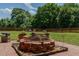 This backyard features a brick firepit area at 2412 Chartwell Ln, Graham, NC 27253