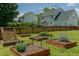 This backyard features small garden plots and a fence at 2412 Chartwell Ln, Graham, NC 27253
