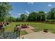 This backyard features a large grassy area and firepit at 2412 Chartwell Ln, Graham, NC 27253