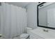 The full bath features a shower with curtain and a vanity with a framed mirror at 2412 Chartwell Ln, Graham, NC 27253