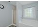 This bathroom features a combination shower and tub along with a decorative window at 2412 Chartwell Ln, Graham, NC 27253