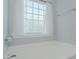 This bathroom features a glass block window and bathtub at 2412 Chartwell Ln, Graham, NC 27253