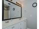 A bathroom with double sinks and a large vanity and mirror, adjacent to a shower at 2412 Chartwell Ln, Graham, NC 27253