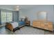 A comfortably appointed bedroom with wood laminate flooring, ceiling fan, and natural light at 2412 Chartwell Ln, Graham, NC 27253