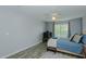 Comfortable bedroom with wood laminate flooring, a ceiling fan, and plenty of natural light at 2412 Chartwell Ln, Graham, NC 27253