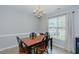Bright dining room featuring a chandelier and a wooden table with black chairs at 2412 Chartwell Ln, Graham, NC 27253