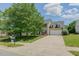 Charming two-story home with blue shutters, an attached garage, and a green lawn in a friendly neighborhood at 2412 Chartwell Ln, Graham, NC 27253