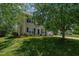 Inviting two-story home with lush green lawn and blue shutters on the windows providing great curb appeal at 2412 Chartwell Ln, Graham, NC 27253